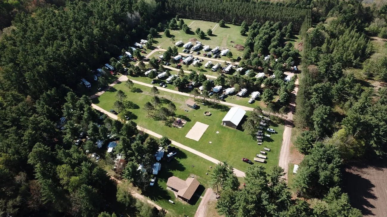An aerial view of a campground surrounded by trees