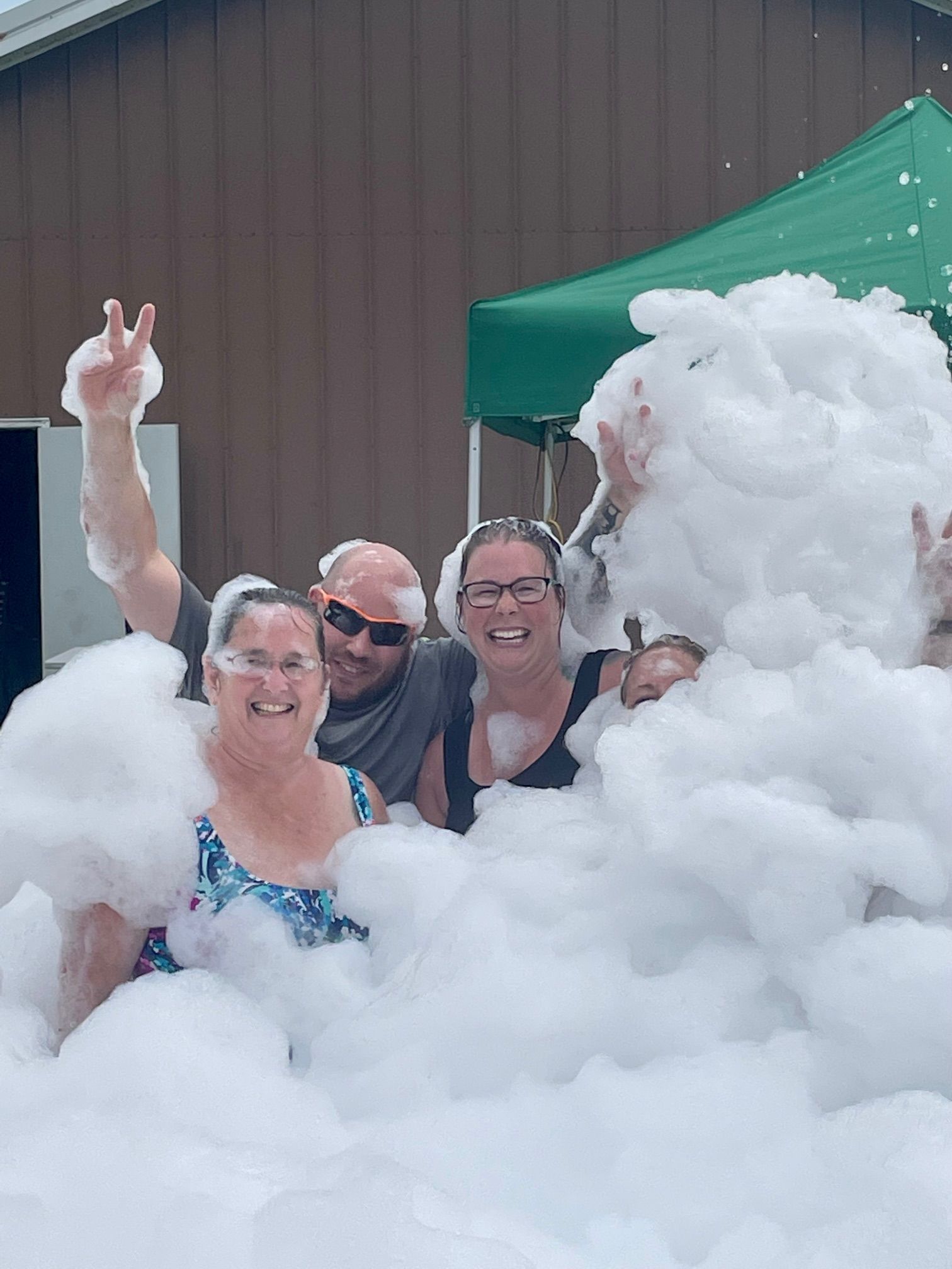 A group of people are standing in a pile of foam.