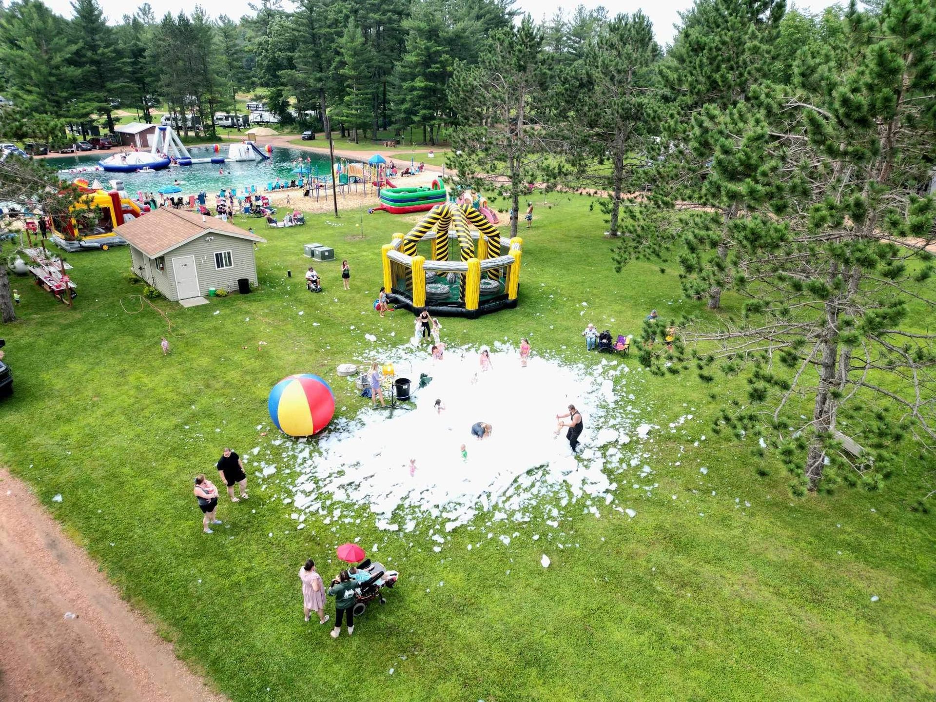 A group of people are playing in a field with foam.