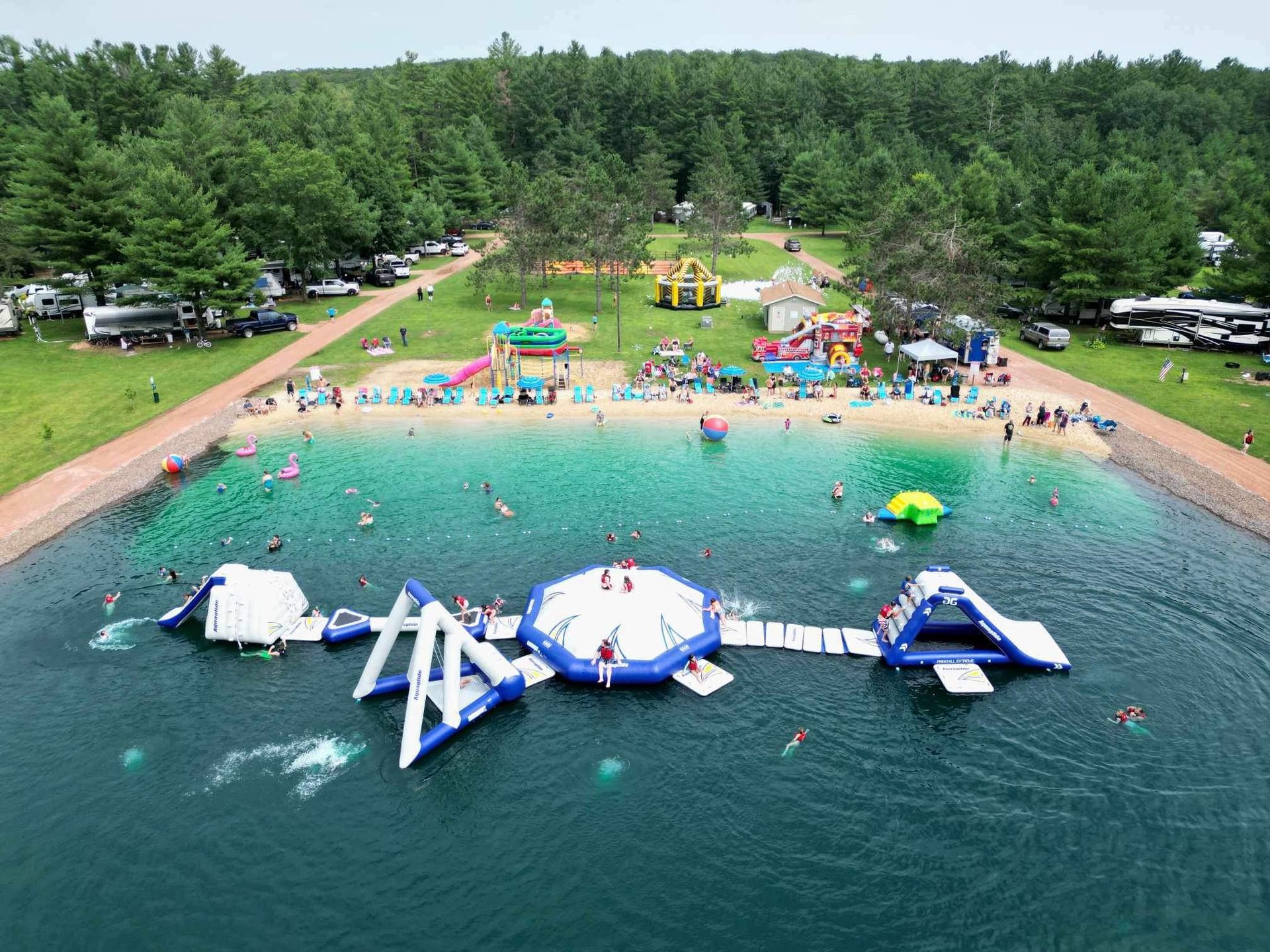 An aerial view of a water park with a lot of people playing in the water.