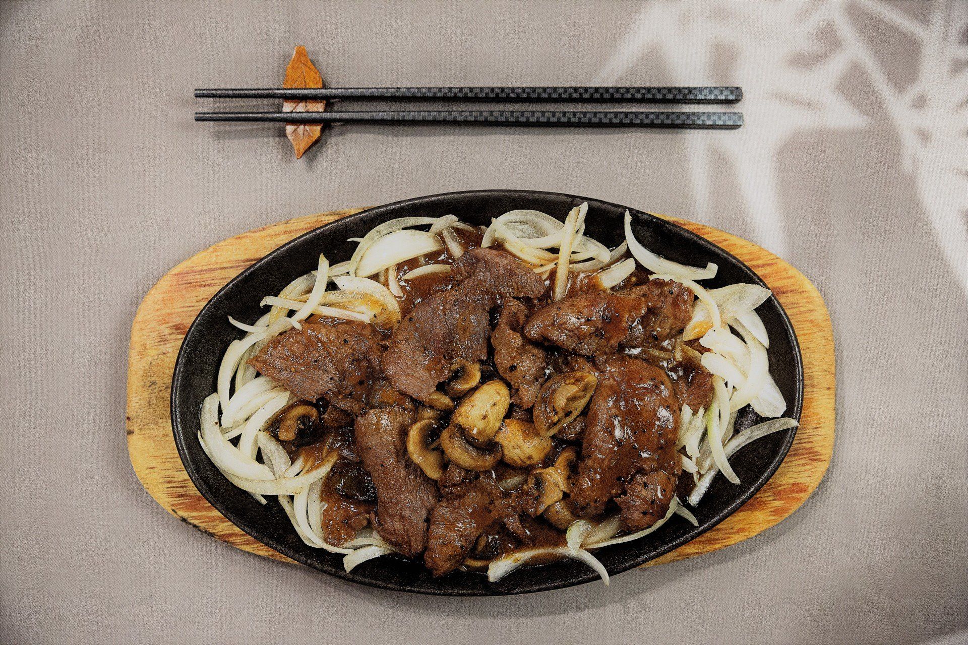 A plate of food with chopsticks on a table.
