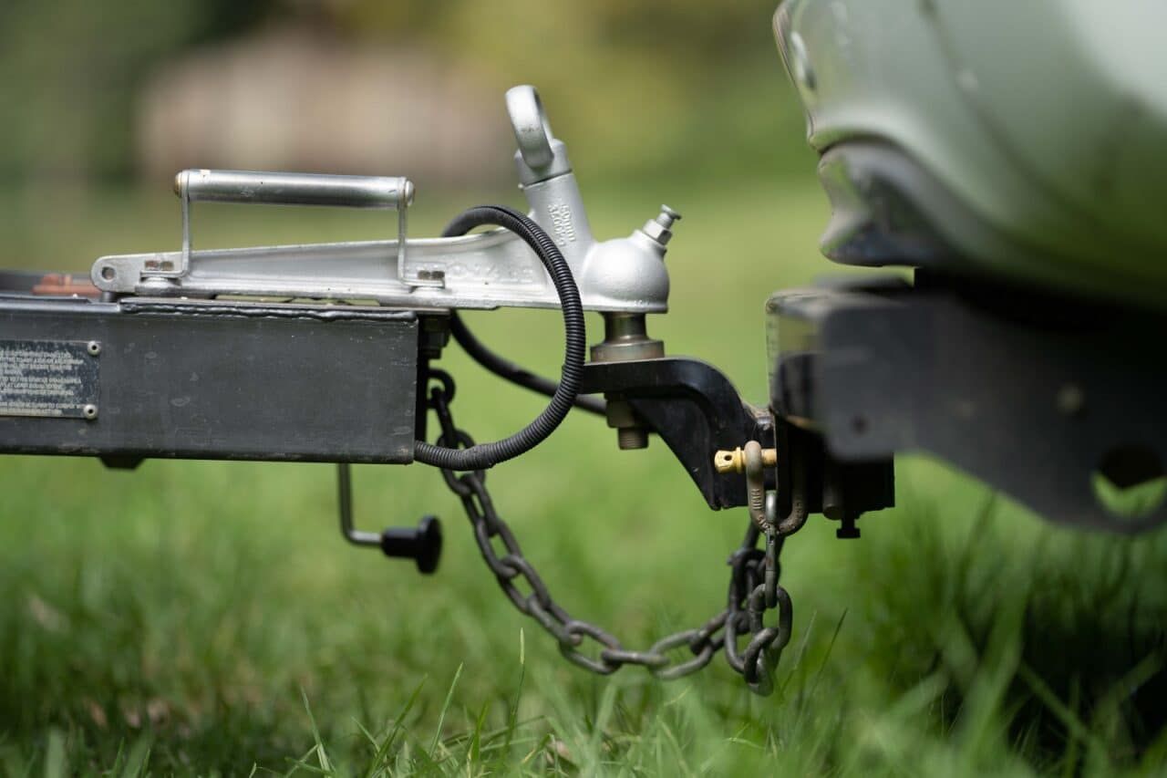Trailer Hitch Connected to a Vehicle, Black Metal, Safety Chains Visible, Outdoors — Track N Back 4x4 In Bamaga, QLD