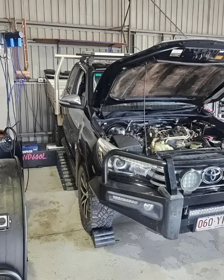 Black Toyota Truck With Open Hood on a Dynamometer in a Garage — Track N Back 4x4 In Mareeba, QLD