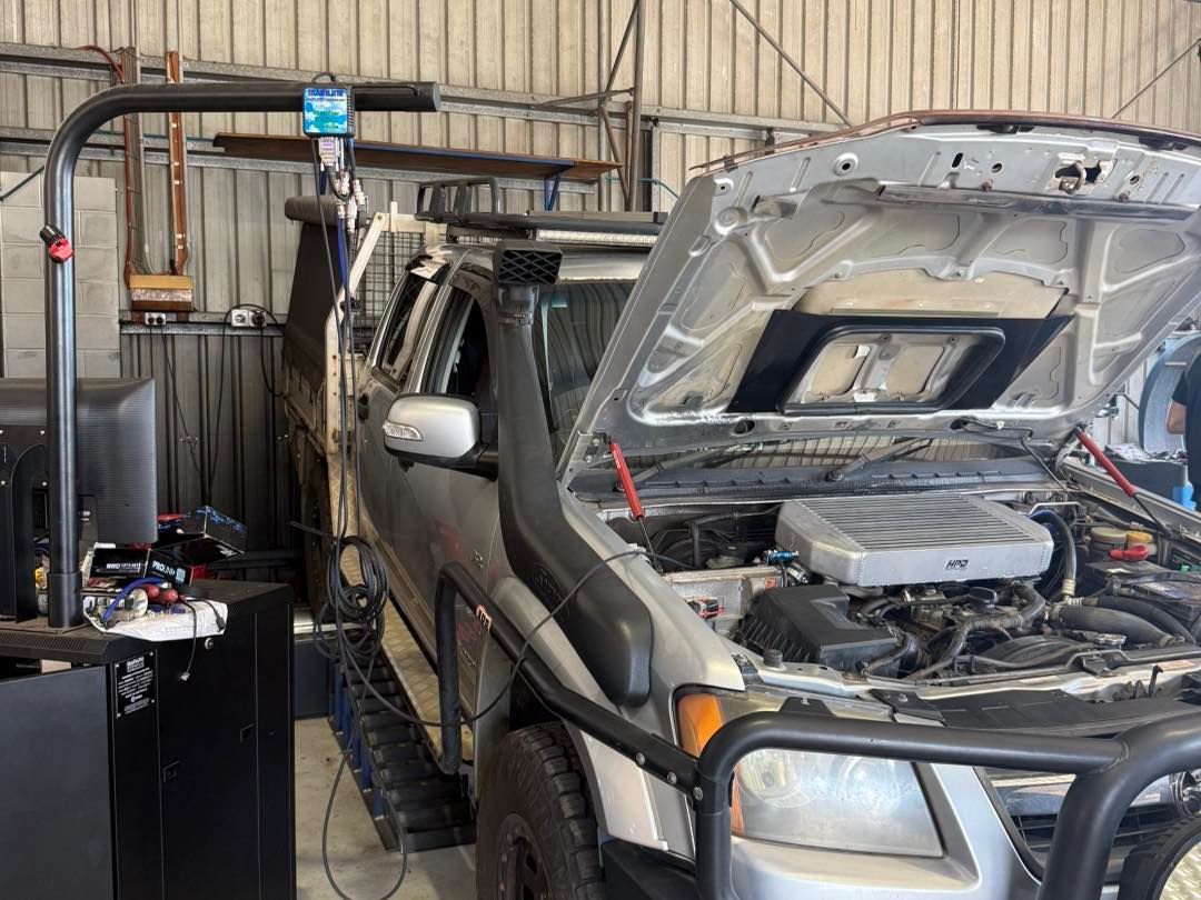 A Silver Truck With Its Hood Open, on a Dyno for Engine Performance Testing in a Garage — Track N Back 4x4 In Mareeba, QLD