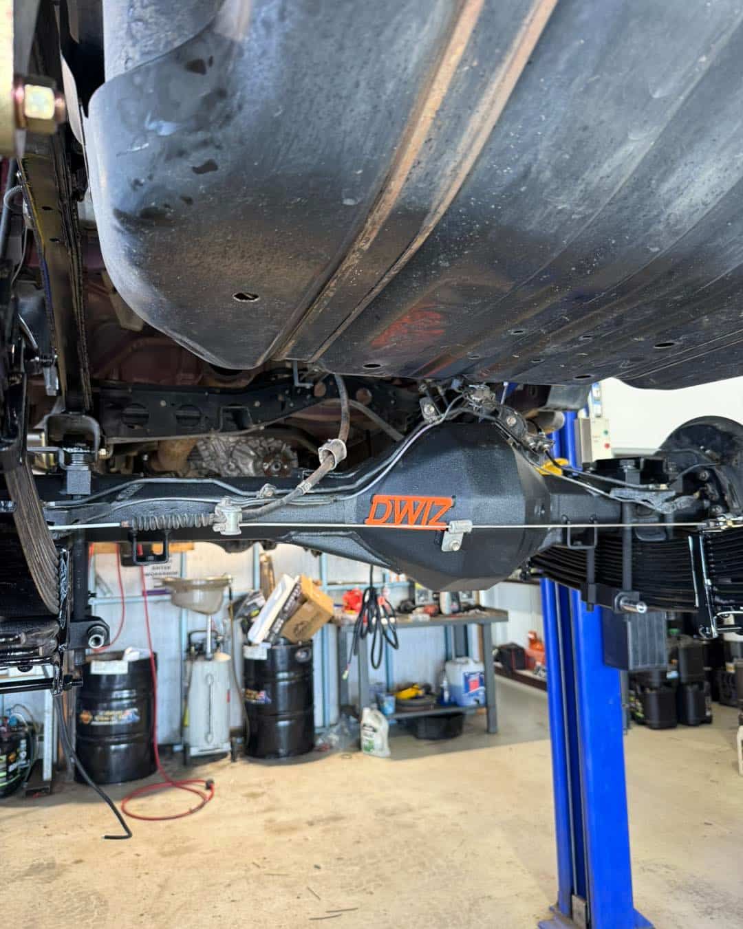 Undercarriage of a Vehicle on a Lift, Showing the Rear Axle — Track N Back 4x4 In Cairns, QLD
