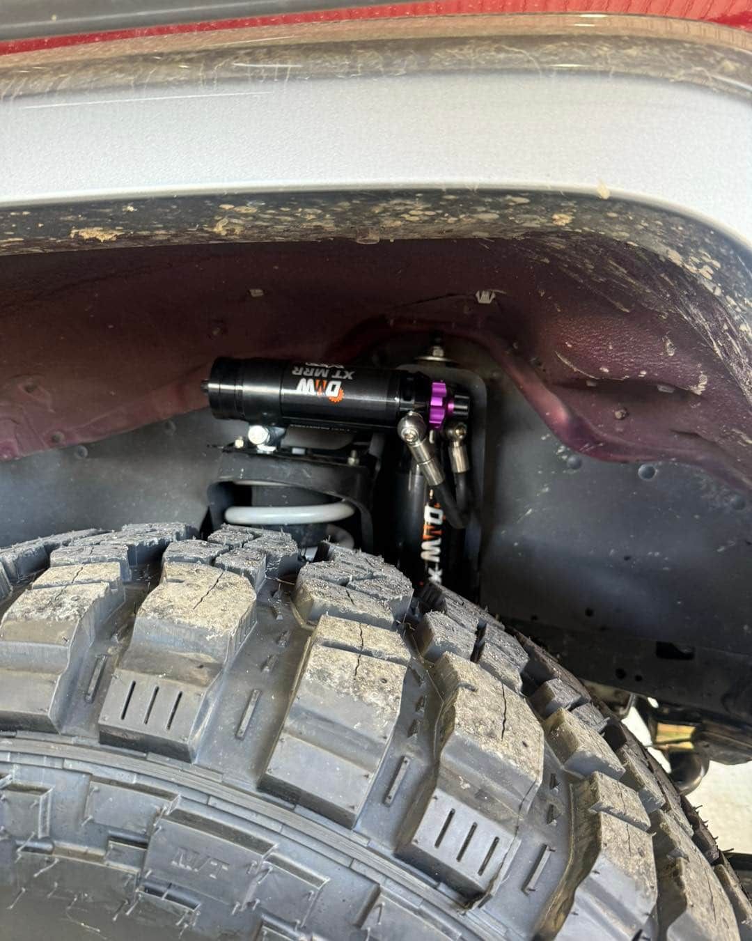 Close-up Of a Lifted Off-road Vehicle's Suspension and Tire in a Wheel Well — Track N Back 4x4 In Townsville, QLD