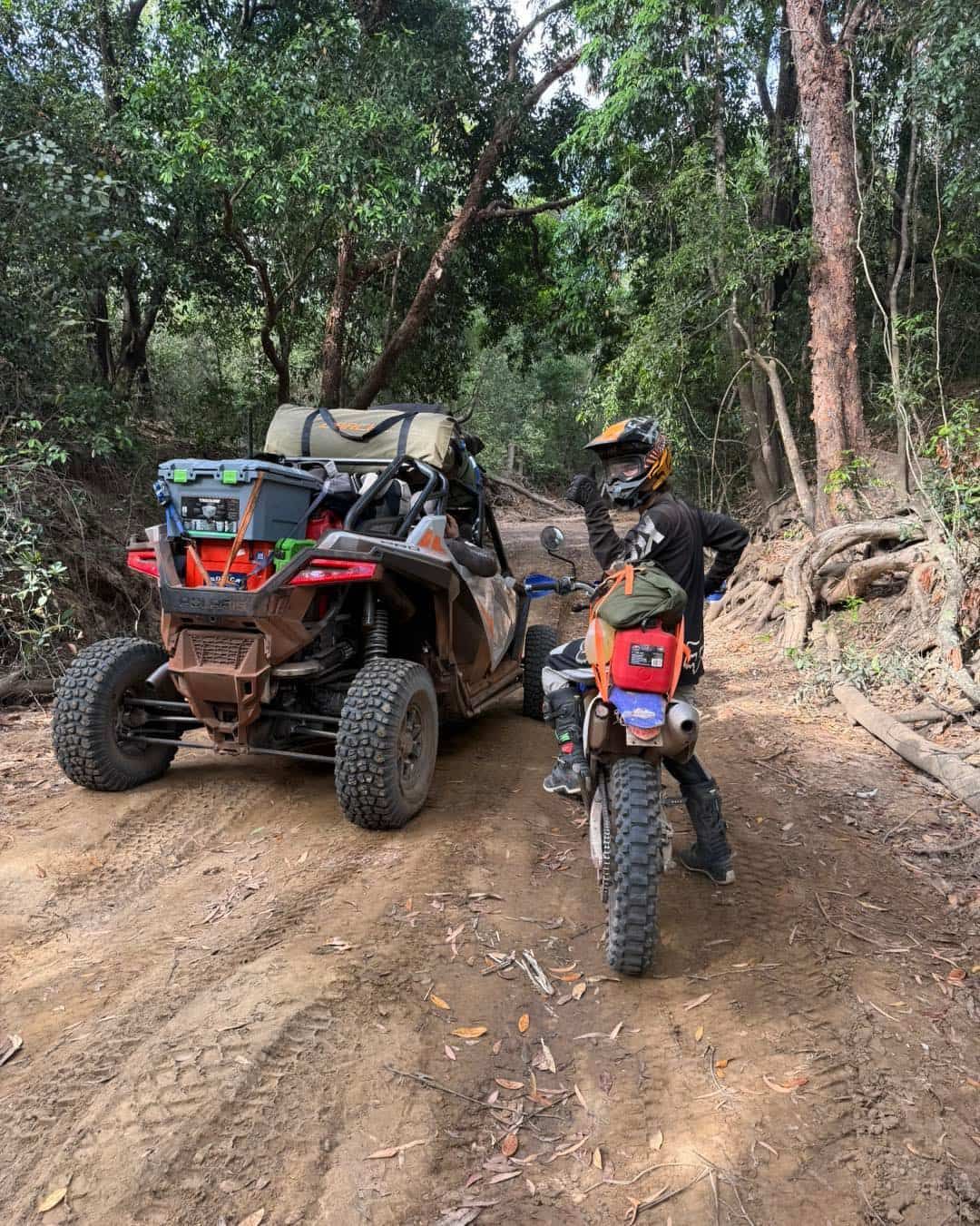 An Off-road Vehicle and Motorcycle Parked on a Dirt Trail in a Forest — Track N Back 4x4 In Mareeba, QLD