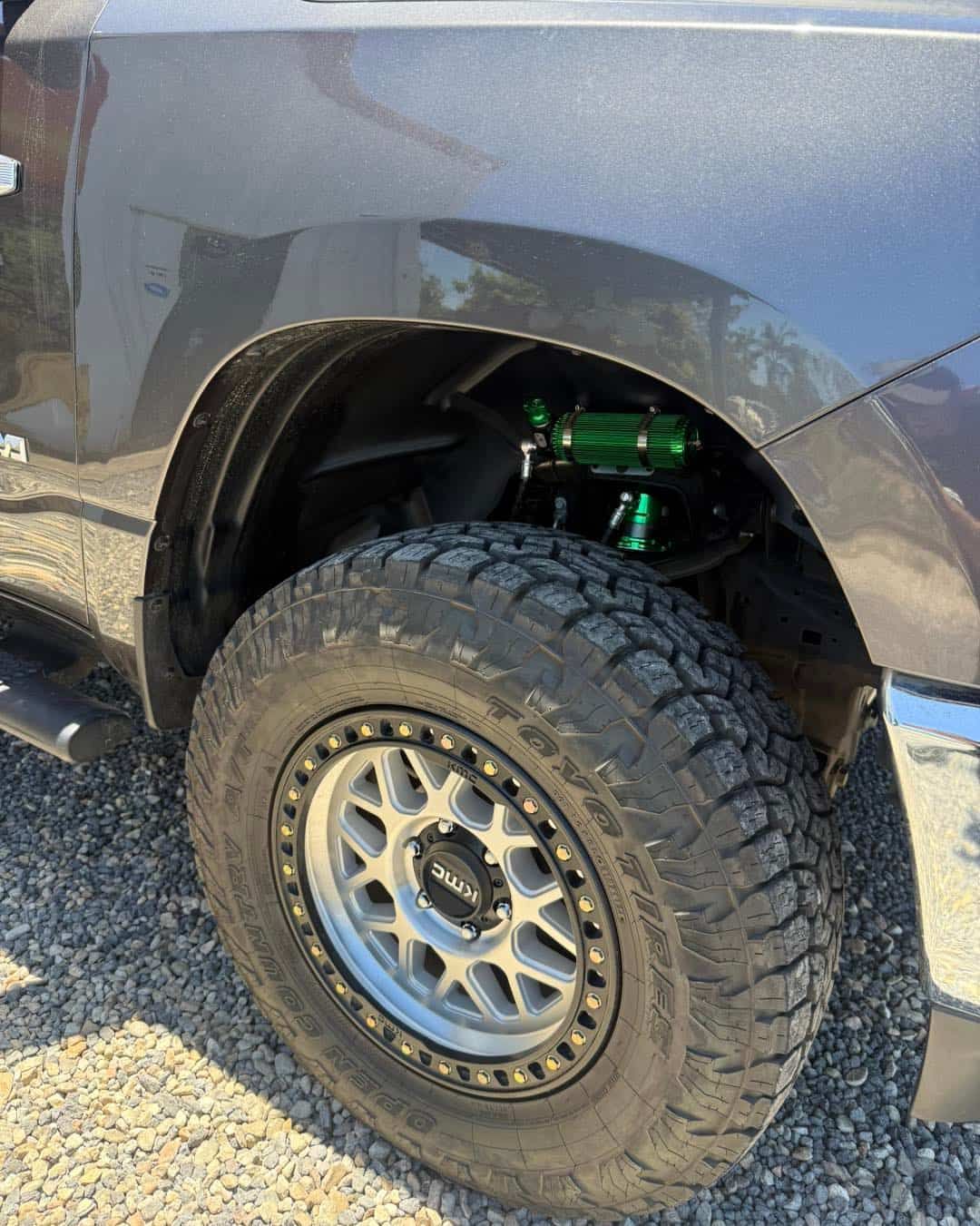Gray Truck Tire and Suspension Components With Green Accents — Track N Back 4x4 In Bamaga, QLD