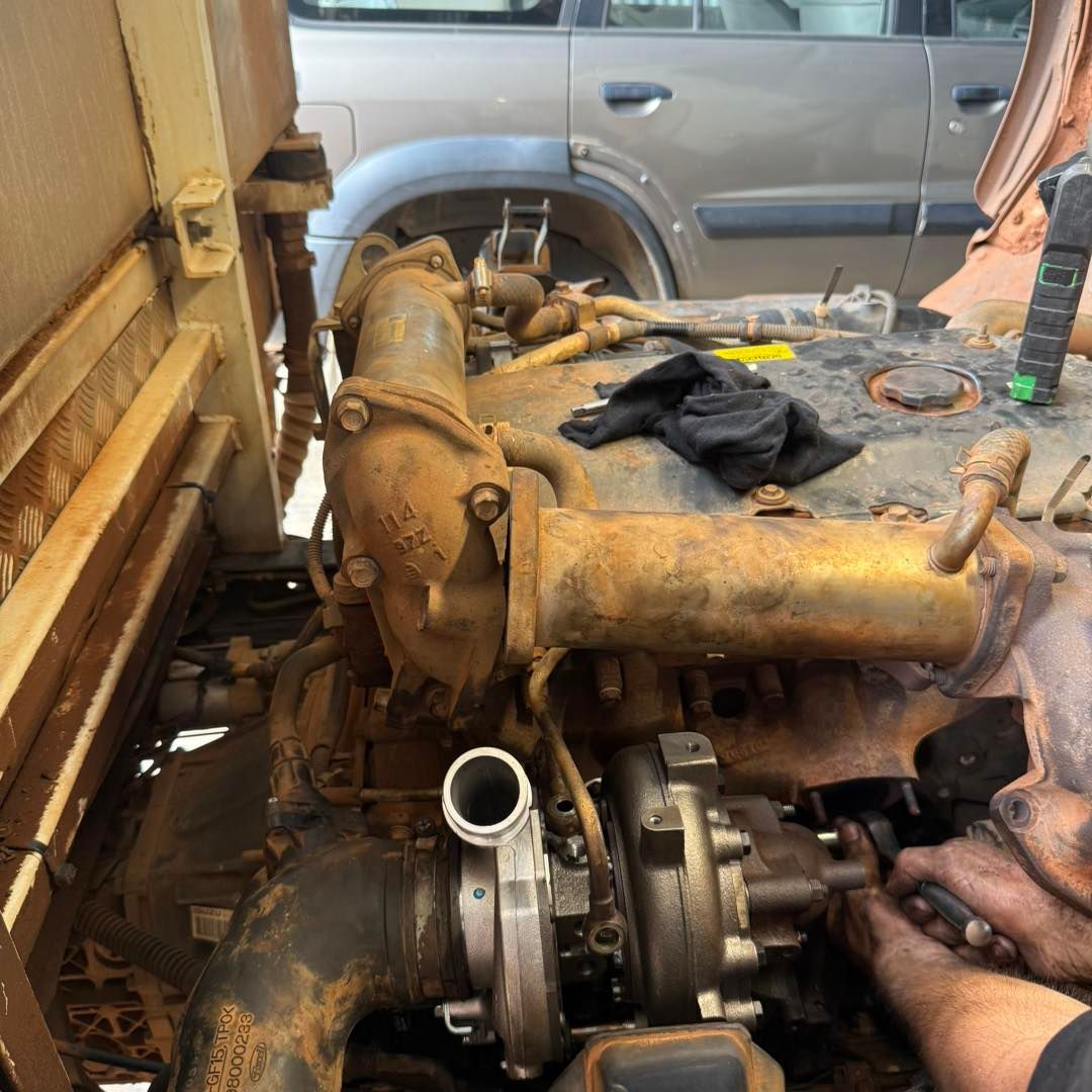 Hands Installing Black Electrical Relays Connected to Wires — Track N Back 4x4 In Townsville, QLD