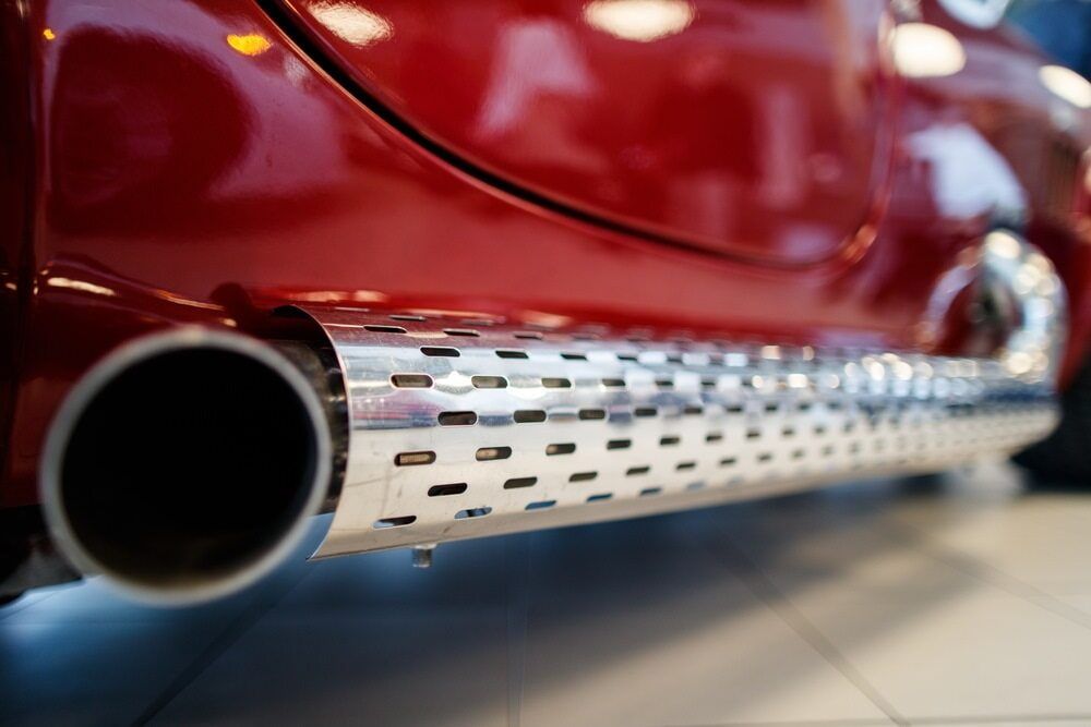 Chrome Side Exhaust Pipe on a Red Vintage Car, Close-up — Track N Back 4x4 In Mt Isa, QLD