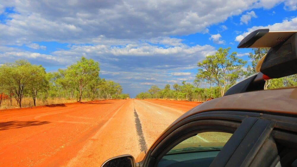 Red Dirt Road Stretches Towards Horizon, Trees Lining Both Sides — Track N Back 4x4 In Thursday Island, QLD