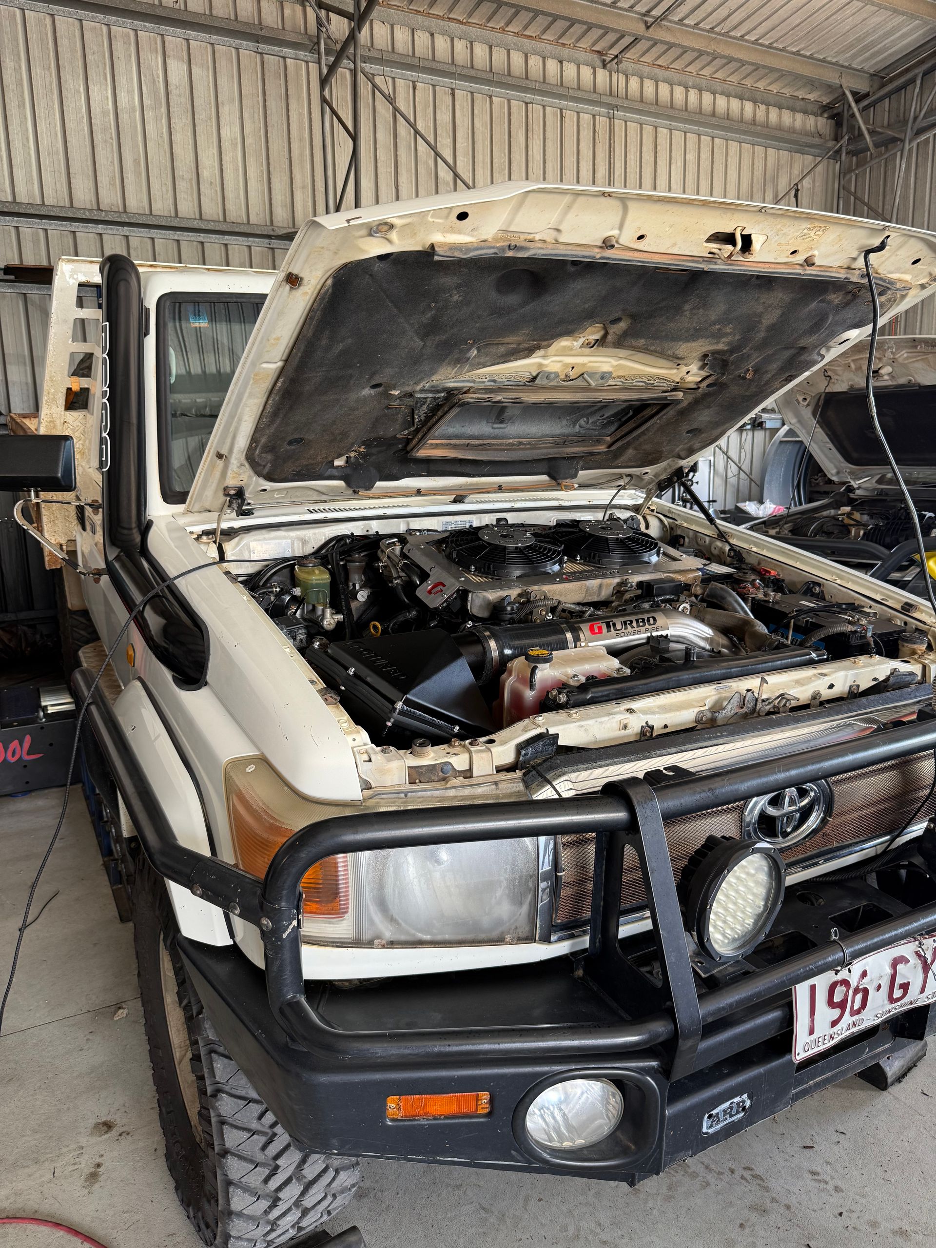 Close-up of a Gray Pickup Truck's Front Wheel and Tire — Track N Back 4x4 In Mareeba, QLD