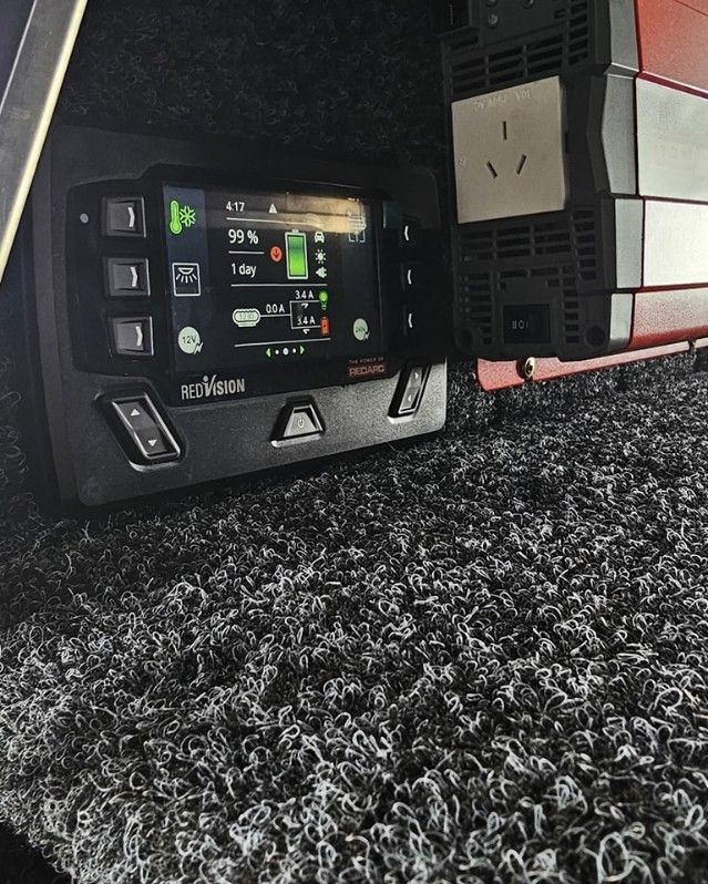 Black Control Panel With a Screen, a Red Inverter, and Black Carpet Flooring — Track N Back 4x4 In Mareeba, QLD