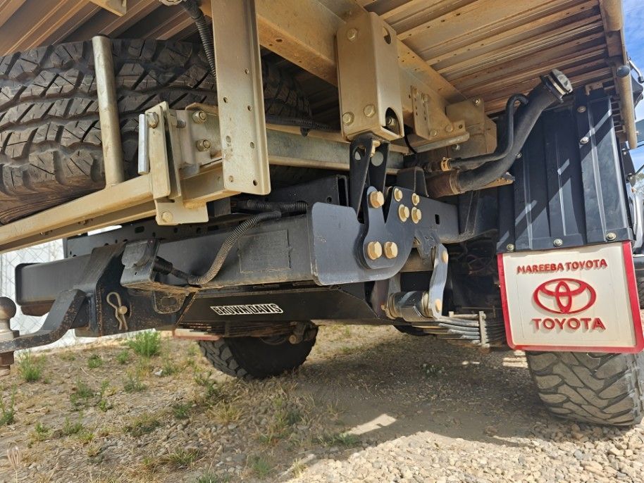Mechanic Working on Car Engine, Wearing Gloves, in a Garage — Track N Back 4x4 In Townsville, QLD