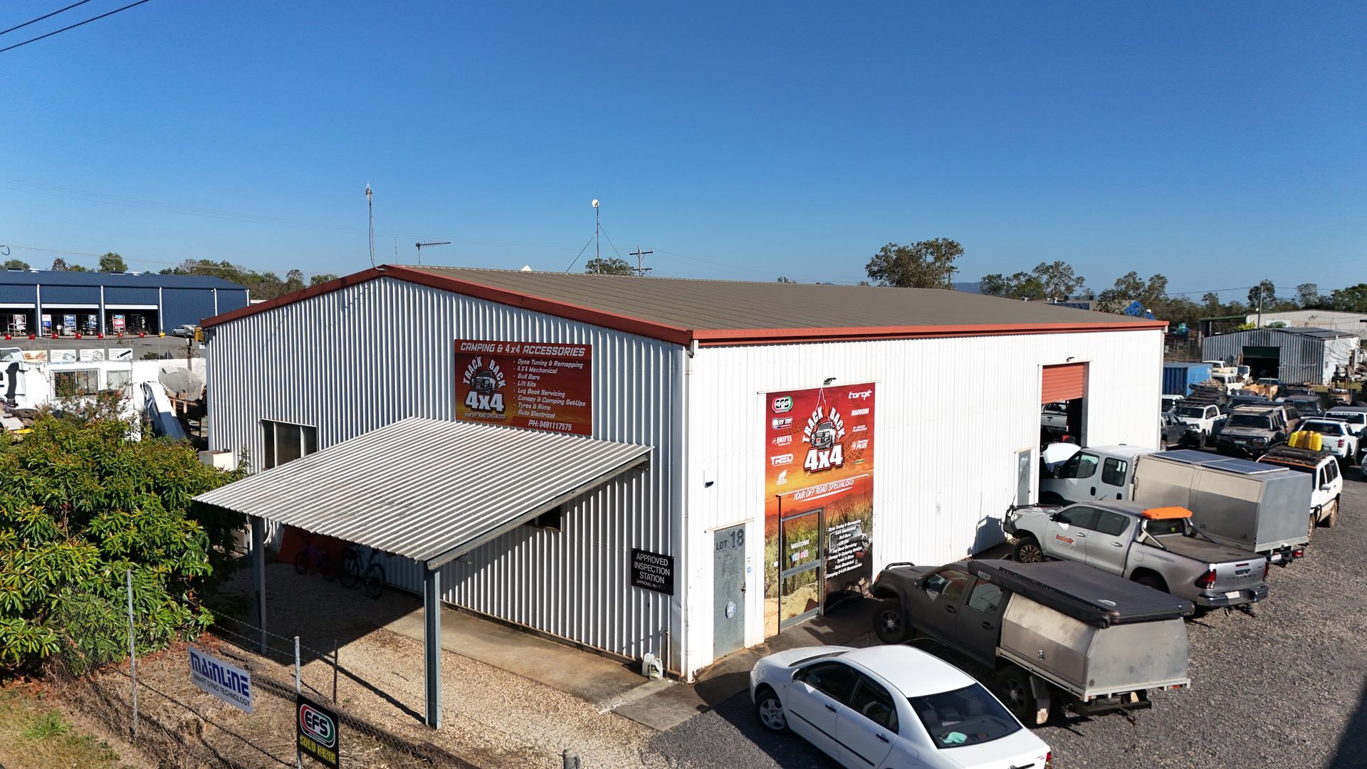 A Silver 4x4 Vehicle Parked Outside a Building — Track N Back 4x4 In Mareeba, QLD