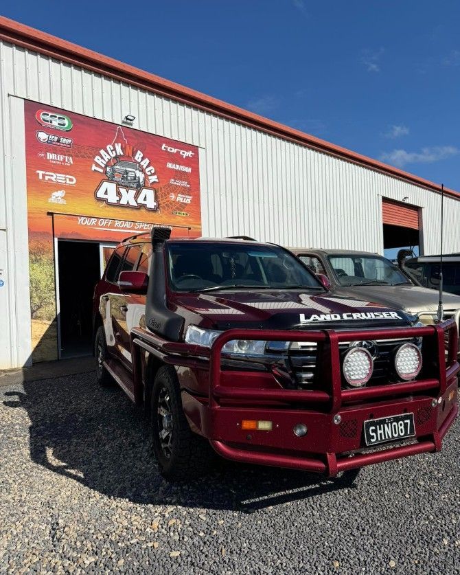 A Burgundy 4x4 Vehicle With a Bull Bar Parked in Front of Track Rack 4x4 — Track N Back 4x4 In Mareeba, QLD