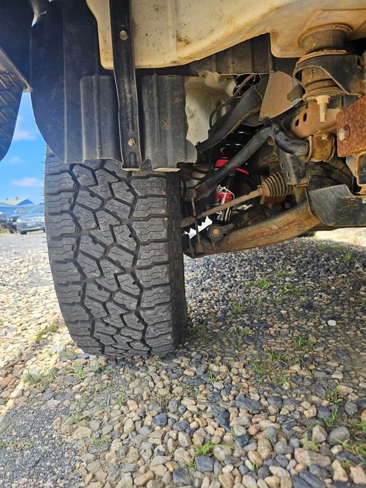 The Front Tire and Suspension of a Vehicle, Viewed From — Track N Back 4x4 In Mareeba, QLD