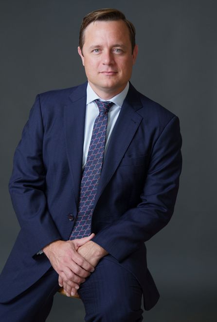 Real Estate, Construction, Property Defect and Damage Attorney Christopher Stow-Serge wearing a dark colored suit, light colored shirt and Hermes tie