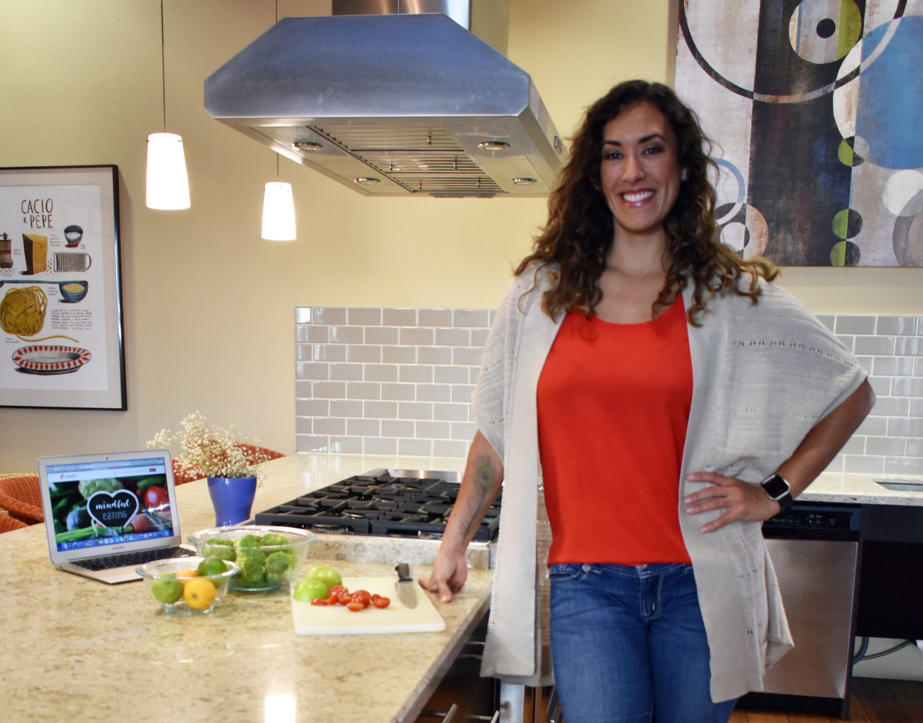 Trainer Alta wearing a red shirt standing in a kitchen