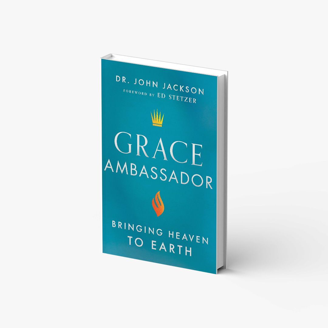 A blue book titled grace ambassador bringing heaven to earth