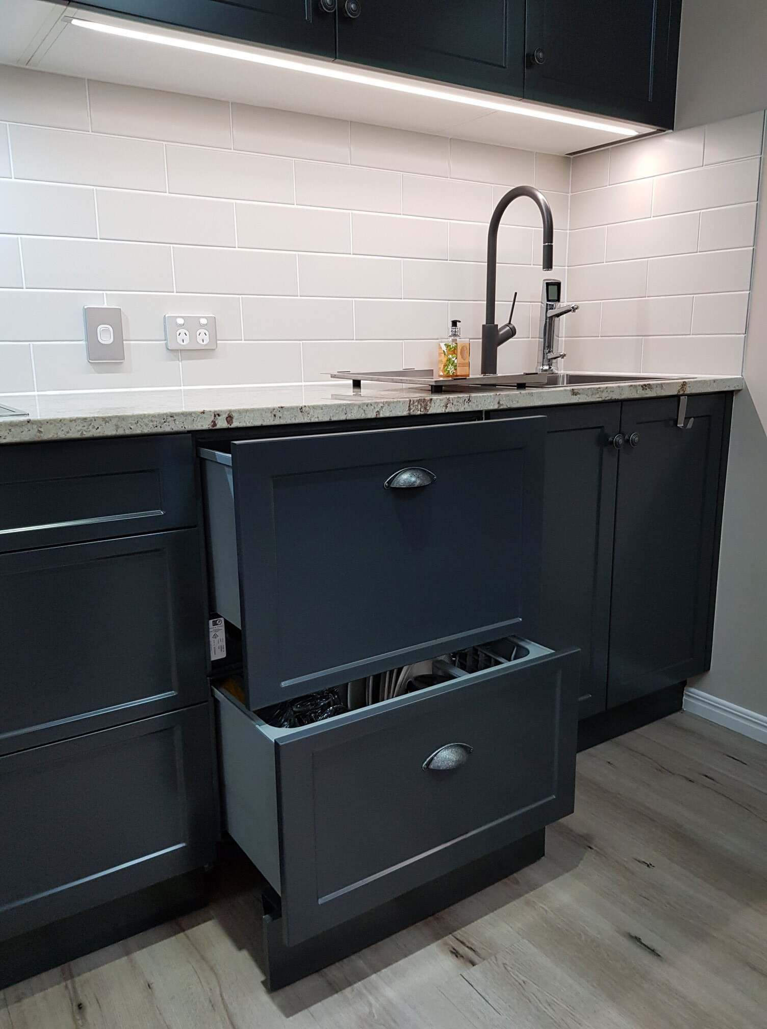 A Kitchen With Black Cabinets and Drawers and a Sink — Regalline Cabinets & Joinery in Svensson Heights, QLD