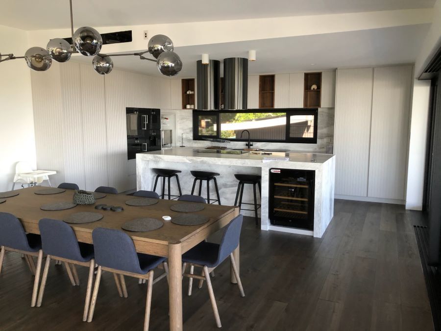 A kitchen with a table and chairs in it