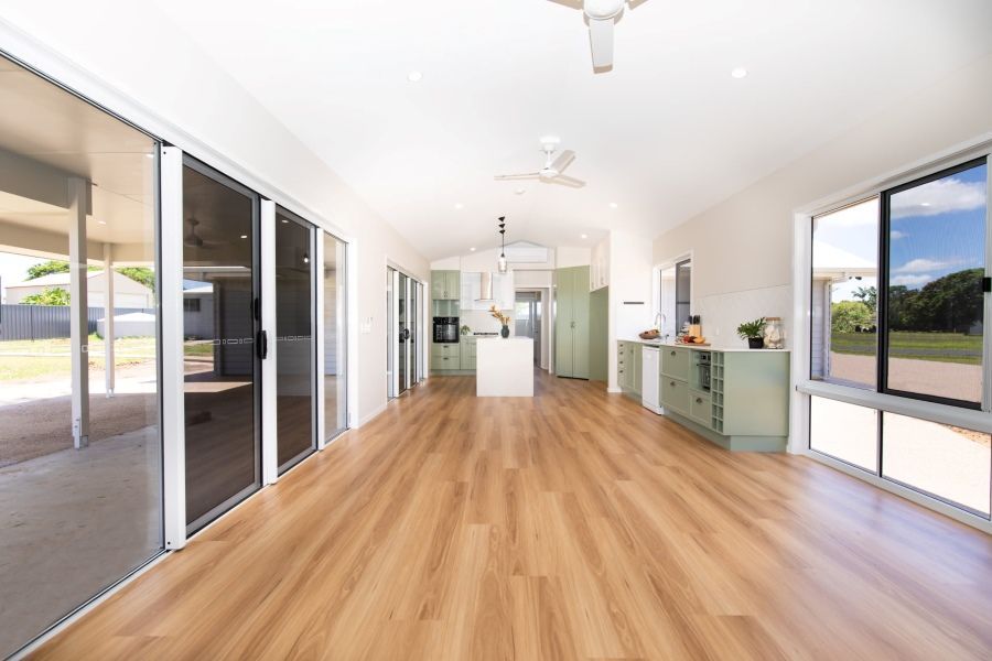A Large Empty Room With Hardwood Floors and Lots of Windows — Regalline Cabinets & Joinery in Svensson Heights, QLD