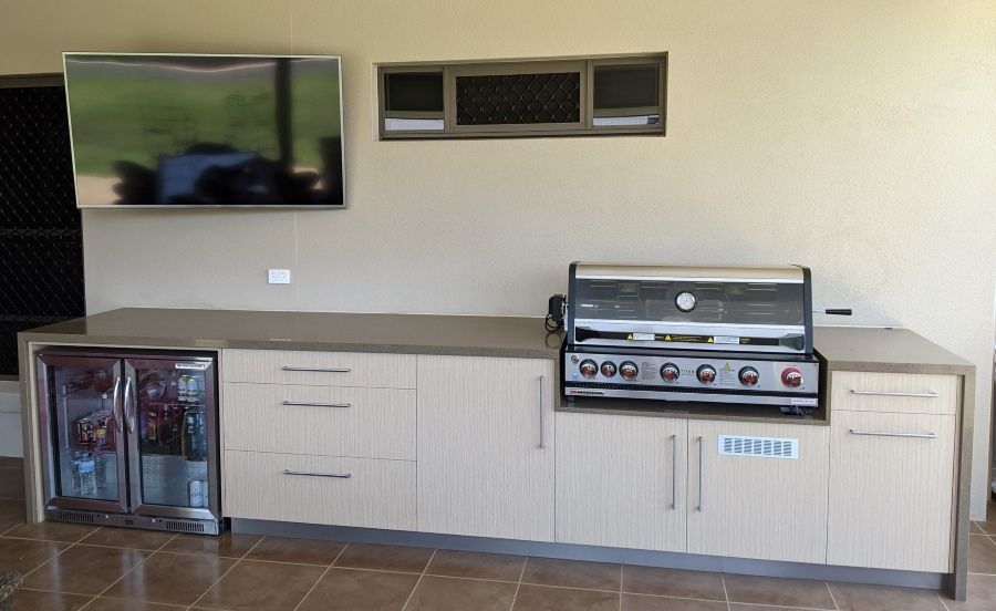 A Kitchen With a Grill and a Flat Screen Tv — Regalline Cabinets & Joinery in Svensson Heights, QLD