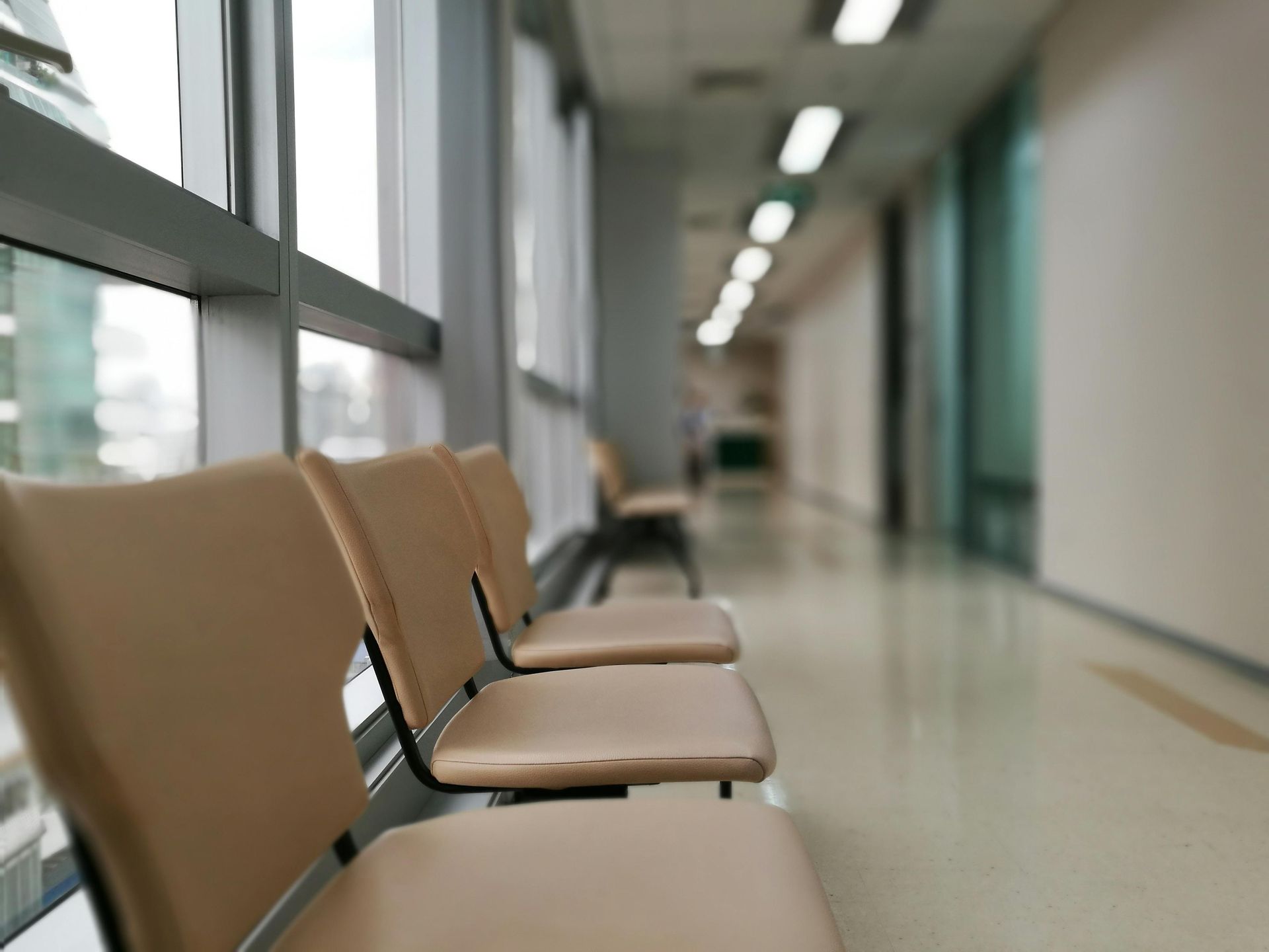 A corridor in a private hospital with seating in a waiting area