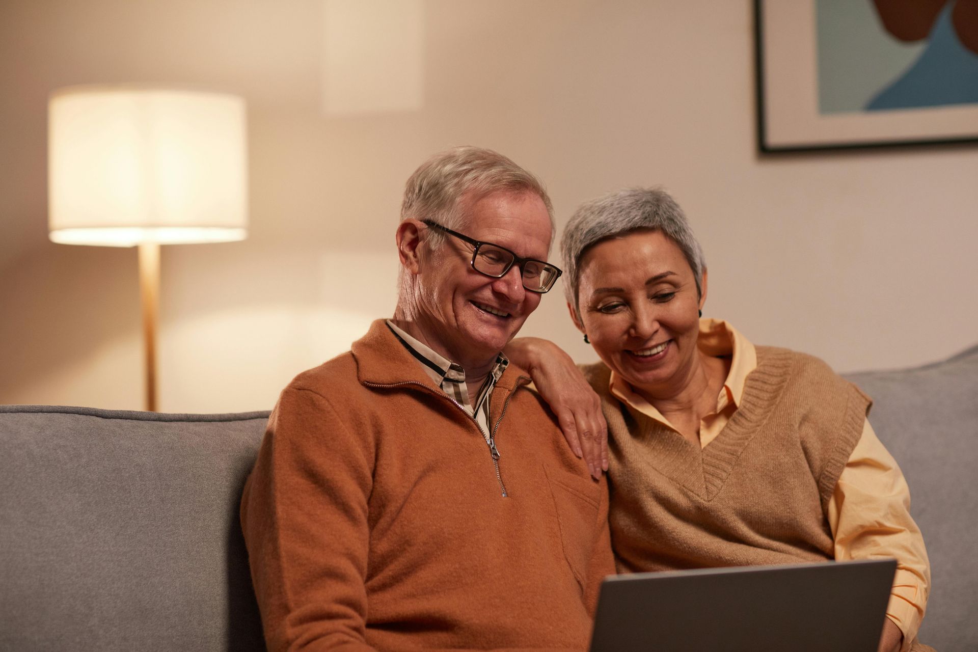 An older couple using a laptop to compare and switch private health insurance