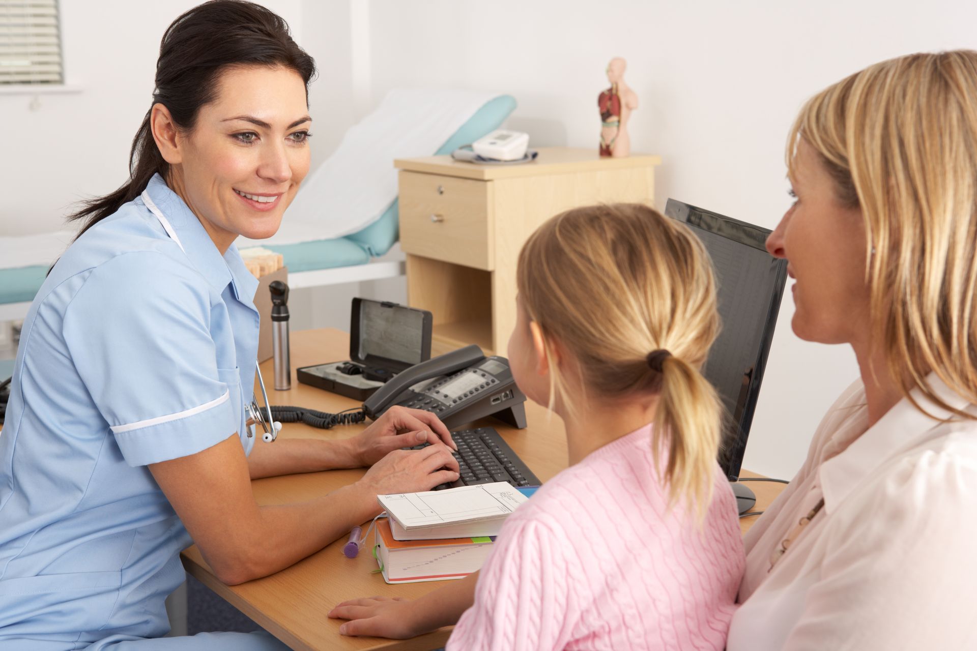 A UK nurse talking to a young family