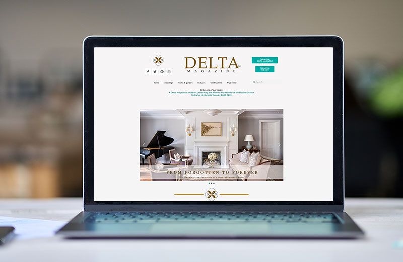 A laptop computer is open to a website on a table.