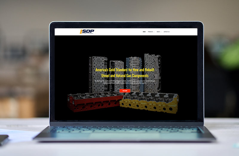 A laptop computer is open to a website on a table.