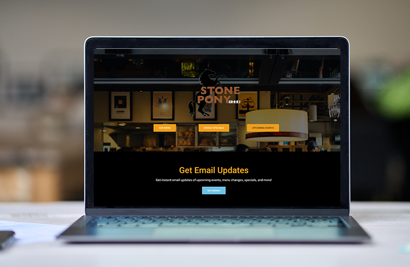 A laptop computer is open to a website for stone pony 's