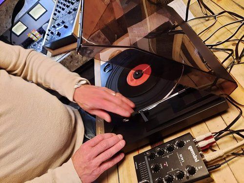 A person is playing a record on a turntable.