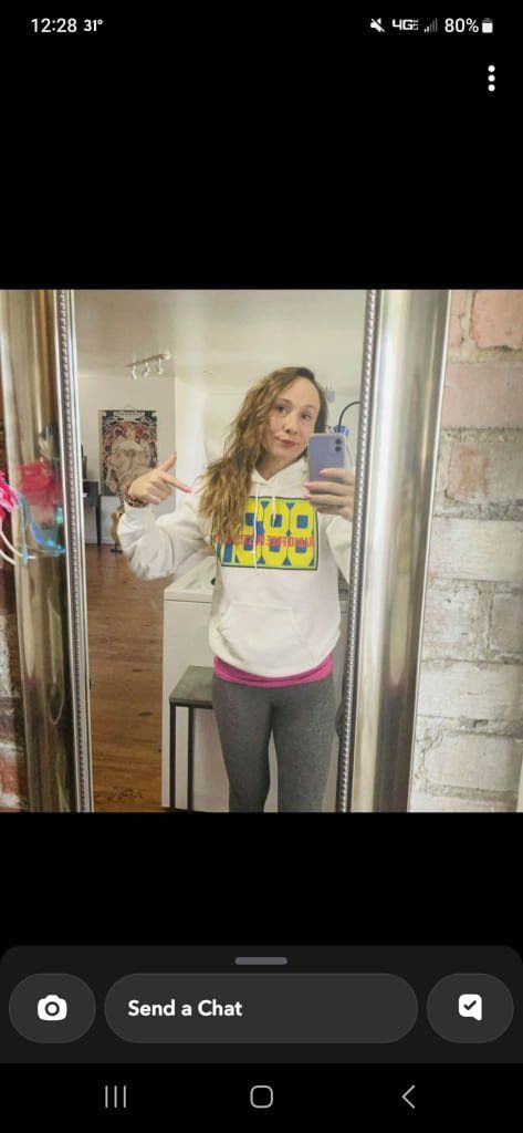 A woman is taking a selfie in front of a mirror.