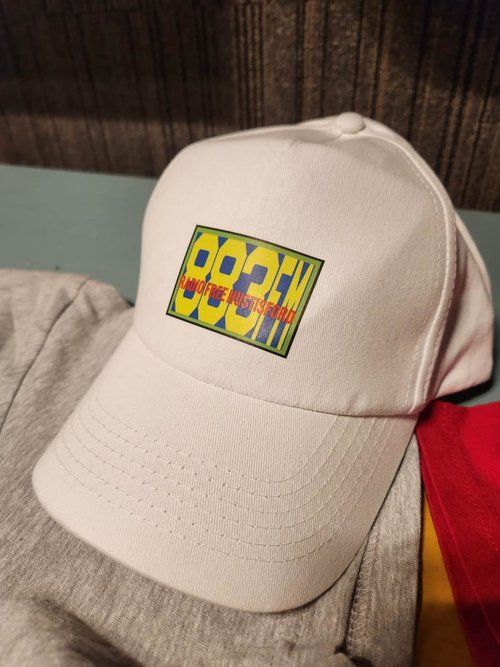 A white baseball cap with the word hood on it