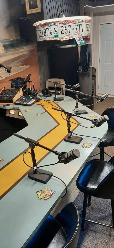 A table with a lot of microphones on it in a room.