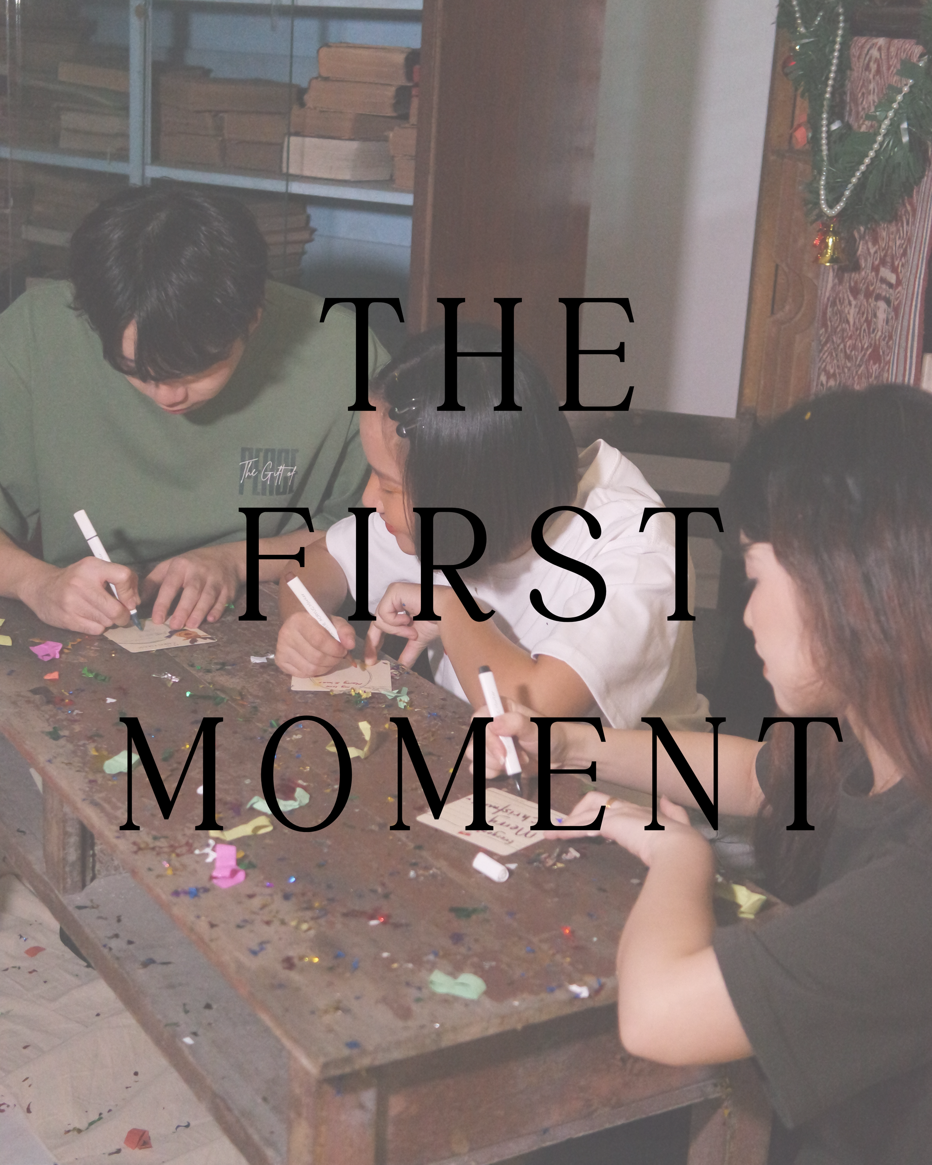 Three people writing on objects at a wooden table. The text 