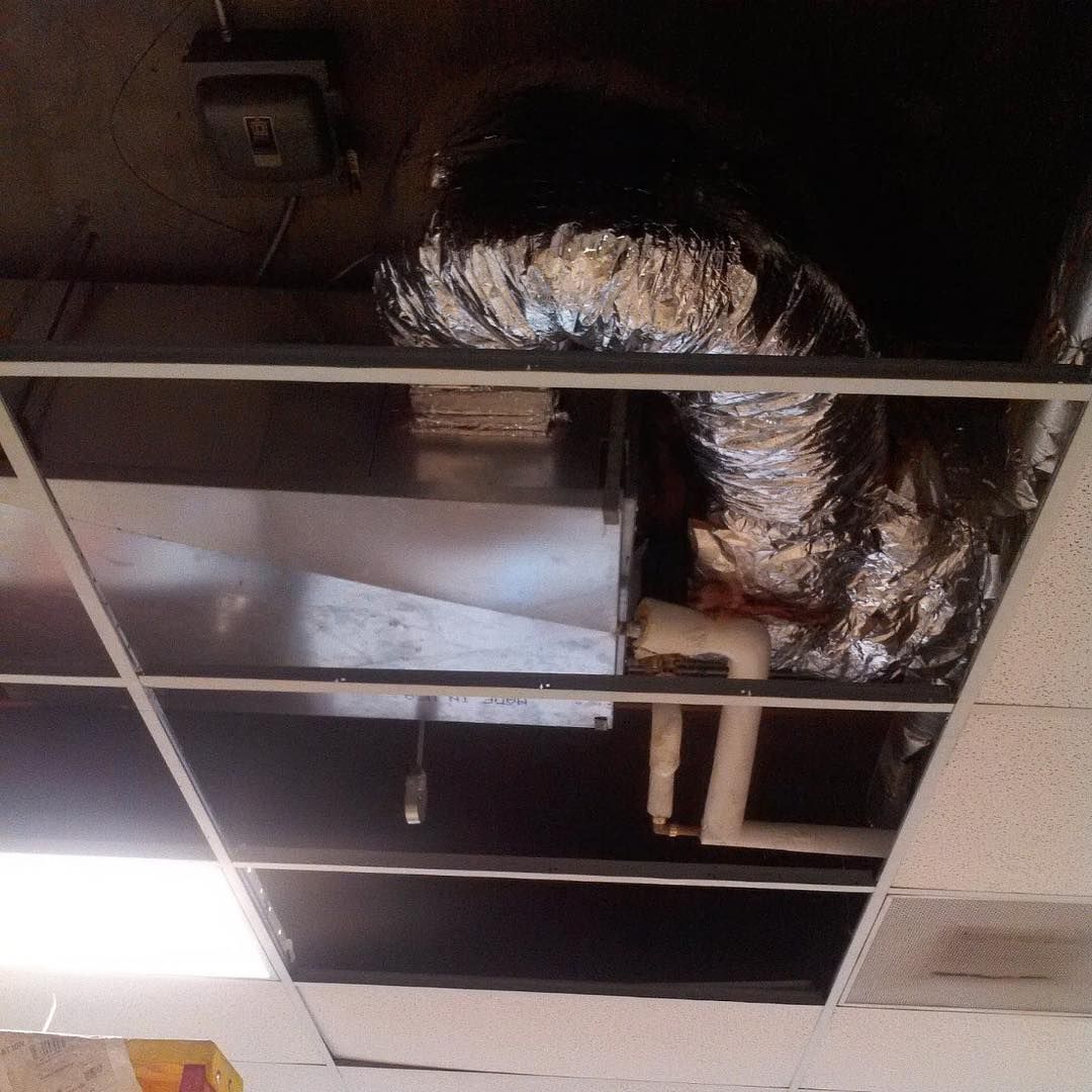 Ceiling with air ducts, metal box, and pipes.