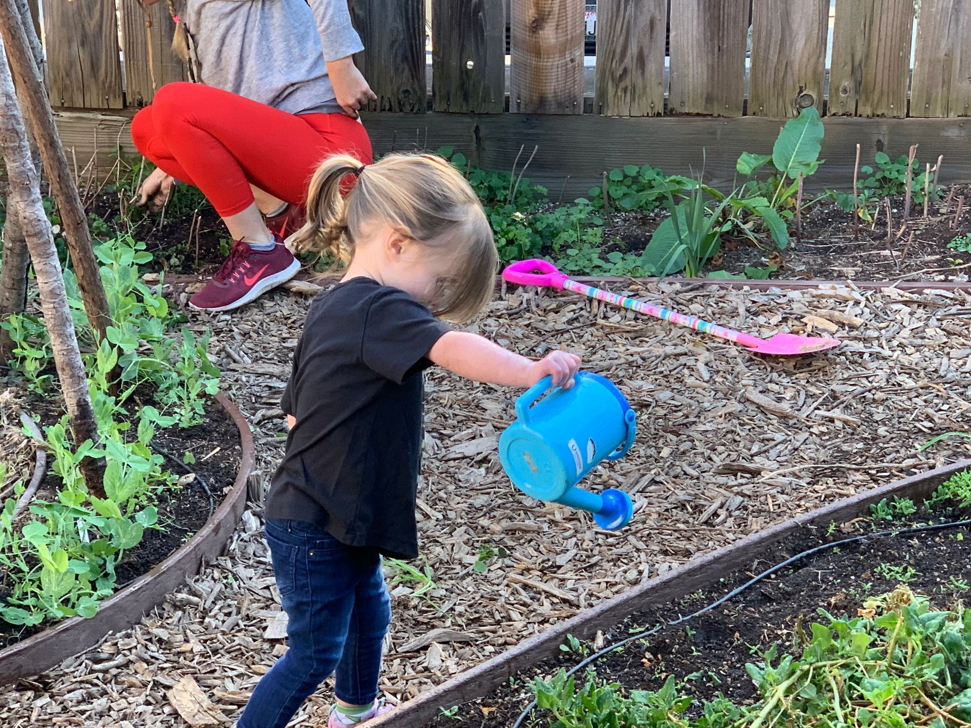 Montessori toddler watering plants