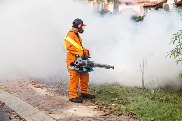 pest control worker spraying for mosquitoes