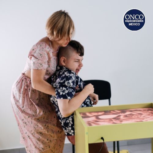 Madre ayudando a un niño con espondilitis.