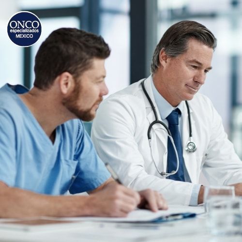 Médico reflexionando con paciente sobre el manejo del cáncer.