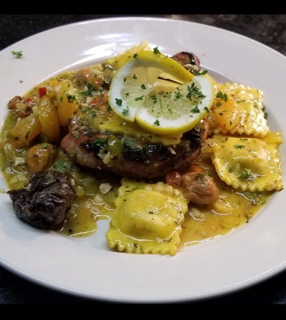 A plate of food with a lemon slice on top