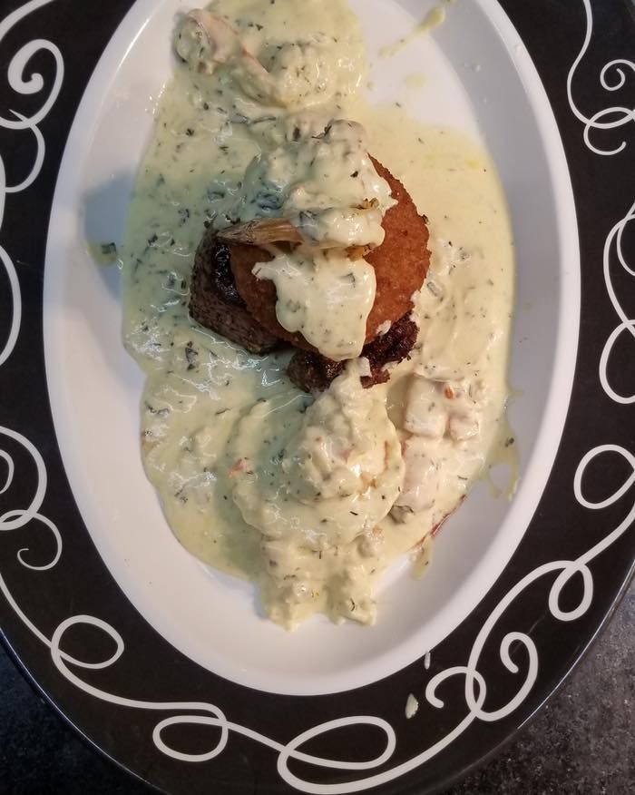 A close up of a plate of food with sauce on it