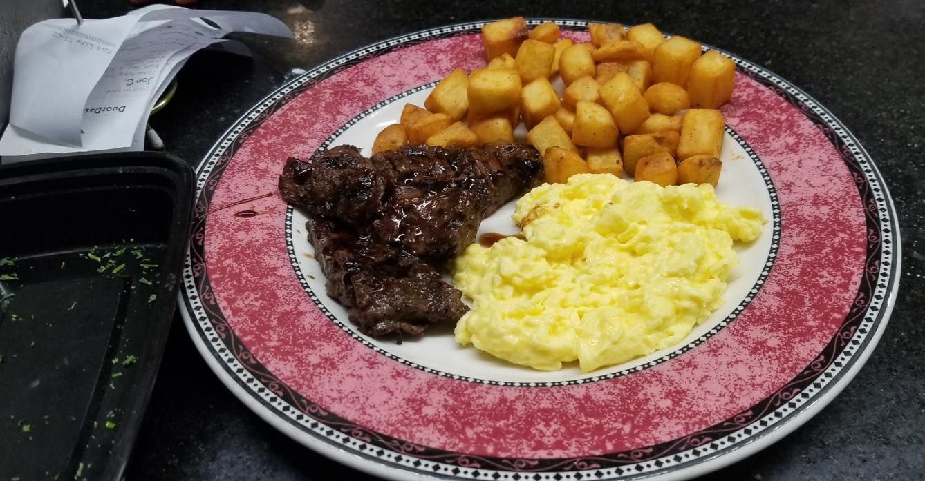 A plate of food with eggs and potatoes on it