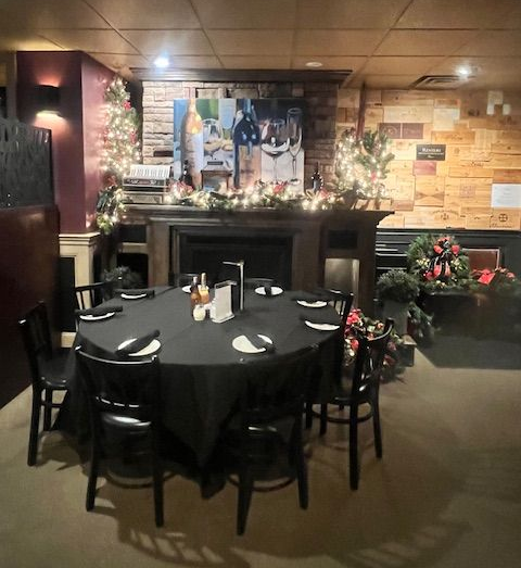 Round table set for a meal in a restaurant, decorated for the holidays.