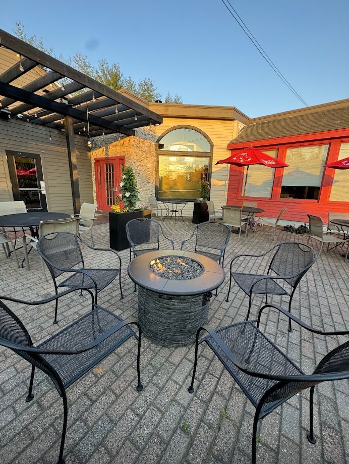 There is a fire pit in the middle of the patio.