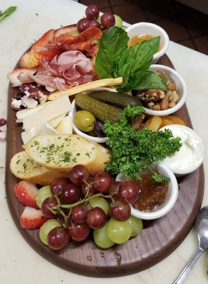 A wooden cutting board with a variety of food on it